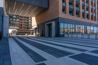 a sidewalk with several black and white stripes that are not visible in a building side view