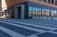 a sidewalk with several black and white stripes that are not visible in a building side view