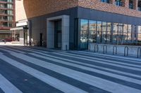 a sidewalk with several black and white stripes that are not visible in a building side view