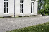 the building is made up of large windows and brick steps and cement blocks with black flooring