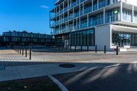 the sun shines on an empty building and street corner with buildings in the background