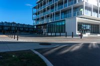 the sun shines on an empty building and street corner with buildings in the background