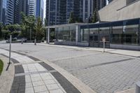 a person sitting at the bench in front of a mall that is empty of people