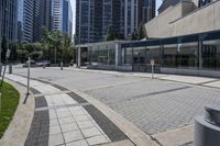 a person sitting at the bench in front of a mall that is empty of people