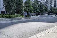 a car driving down an empty street lined with tall buildings and trees in the background