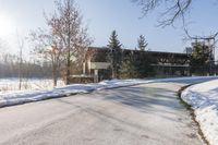 an old, wooden building sits in the background as a snow covered street is covered with snow