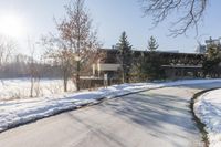 an old, wooden building sits in the background as a snow covered street is covered with snow