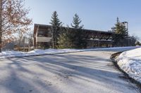 an old, wooden building sits in the background as a snow covered street is covered with snow