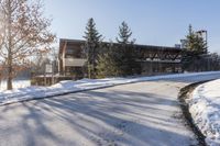 an old, wooden building sits in the background as a snow covered street is covered with snow