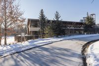 an old, wooden building sits in the background as a snow covered street is covered with snow