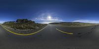 the road that goes from an empty desert to a beautiful blue sky in the sun