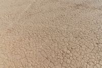 closeup view of cracks in a dry field with no vegetation around it, from below