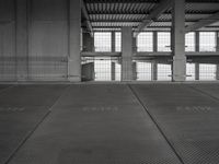 a black and white photo of a building with the door open on a street area