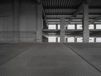 a black and white photo of a building with the door open on a street area