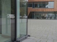 a glass door at an office building is open to let people in, and it's also showing