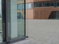 a glass door at an office building is open to let people in, and it's also showing