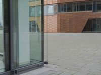 a glass door at an office building is open to let people in, and it's also showing