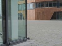 a glass door at an office building is open to let people in, and it's also showing