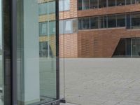 a glass door at an office building is open to let people in, and it's also showing