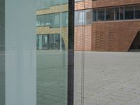 a glass door at an office building is open to let people in, and it's also showing