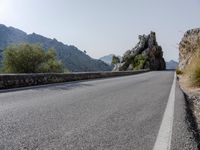 Open Road in Spain with Low Mountain Landscape