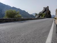 Open Road in Spain with Low Mountain Landscape