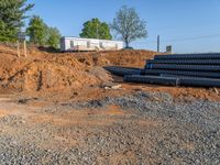 a picture of a building being built on a field near a forest in the background