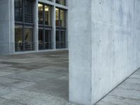 a building with windows and a floor made out of concrete has tile floors in front of it