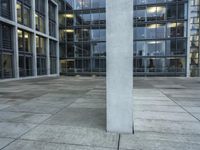 a building with windows and a floor made out of concrete has tile floors in front of it