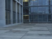 a building with windows and a floor made out of concrete has tile floors in front of it