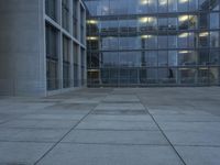 a building with windows and a floor made out of concrete has tile floors in front of it