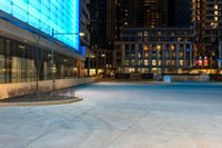 the sidewalk is empty of people walking around it as dusk falls over the buildings and skyscrapers