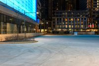 the sidewalk is empty of people walking around it as dusk falls over the buildings and skyscrapers