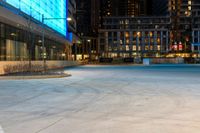 the sidewalk is empty of people walking around it as dusk falls over the buildings and skyscrapers