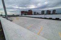 a large roof that has some yellow lines on it, in front of a skyline