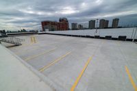 a large roof that has some yellow lines on it, in front of a skyline