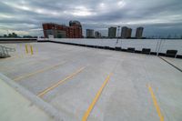 a large roof that has some yellow lines on it, in front of a skyline