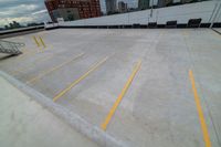 a large roof that has some yellow lines on it, in front of a skyline