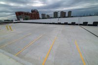 a large roof that has some yellow lines on it, in front of a skyline