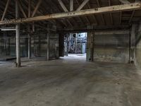 an empty industrial warehouse with exposed beams and large windows in the space outside on a sunny day