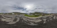 a fish - eye lens is showing a road and mountain range in the background of this image