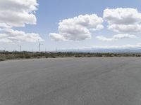 several windmills can be seen in the background as well as a paved road in the foreground