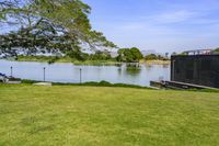 an open space with a small pond on one side, and a concrete structure on the other