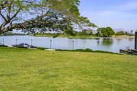 an open space with a small pond on one side, and a concrete structure on the other