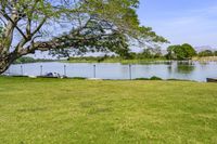 an open space with a small pond on one side, and a concrete structure on the other