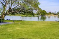 an open space with a small pond on one side, and a concrete structure on the other