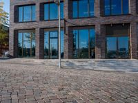 the large building is made of concrete and has metal railings around it, which are made of brick