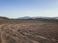 Open Space Road with Mountain Range and Cloudy Sky