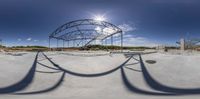 a skate park is shown in 360 - 360 mode with a metal structure above it