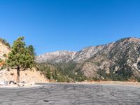 an empty street in front of a mountain range in the united states of america during the day